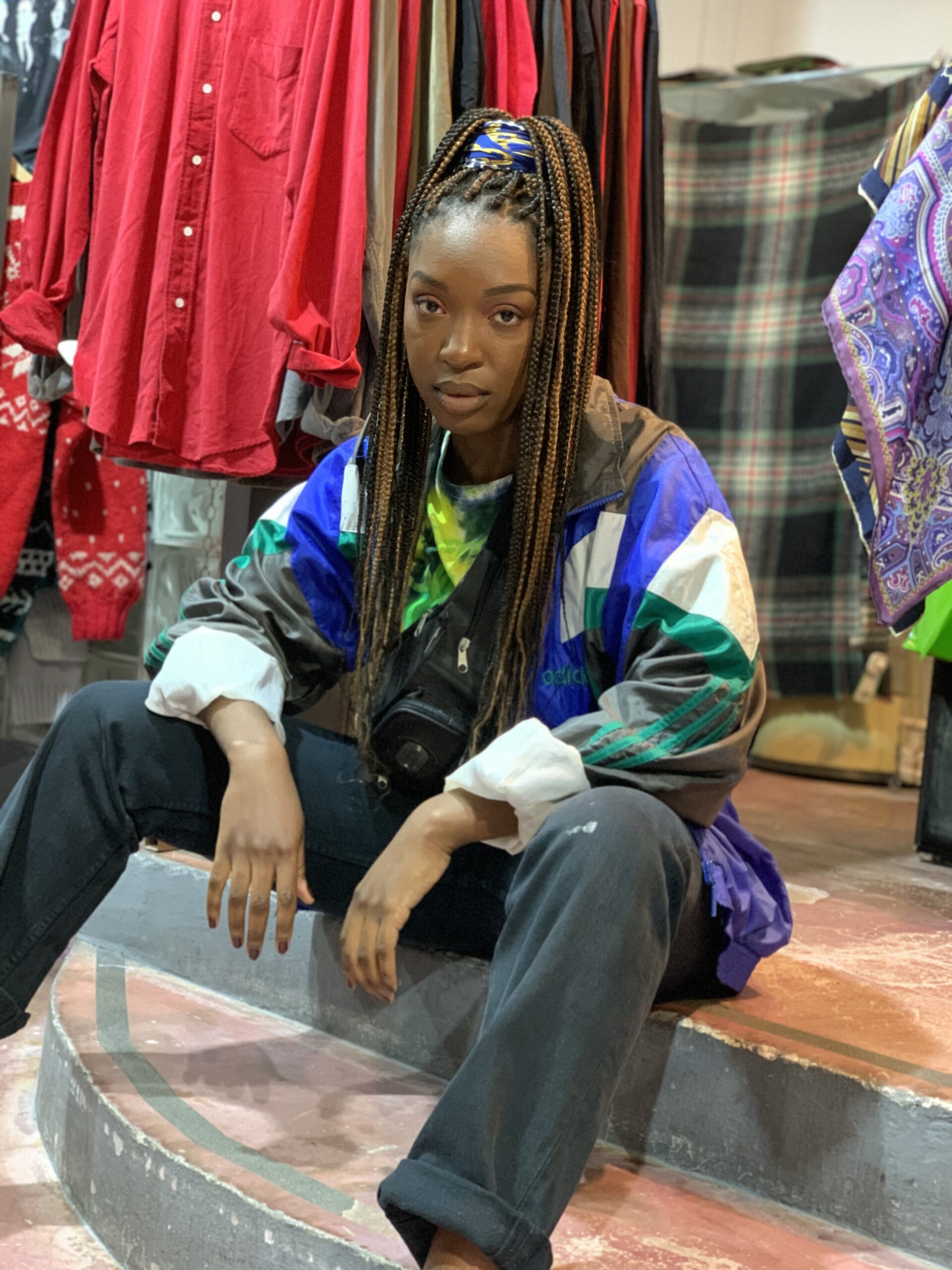 person holding assorted clothes in wooden hanger