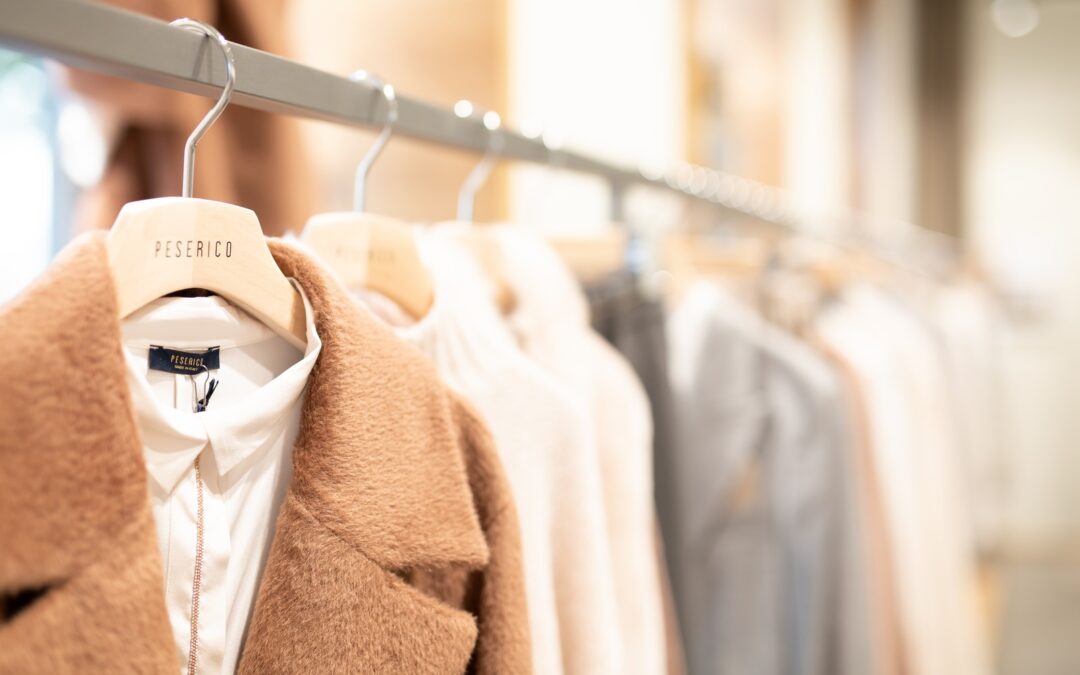 brown coat hanged on white plastic hanger