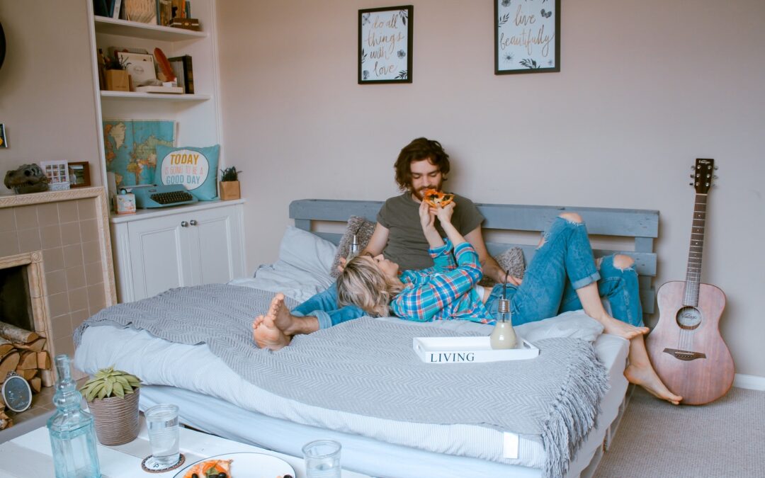 man and woman lying on bed